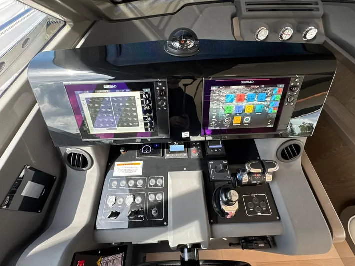 Time To Fly Yacht Photos Pics Control panel of a 2022 Ferretti Yachts 550 with dual Simrad displays.