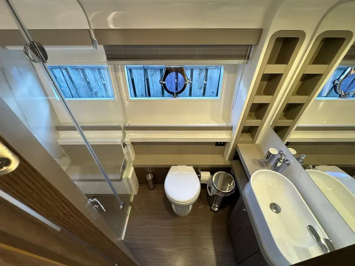 Time To Fly Yacht Photos Pics Luxurious bathroom in 2022 Ferretti Yachts 550, featuring modern fixtures and elegant design.