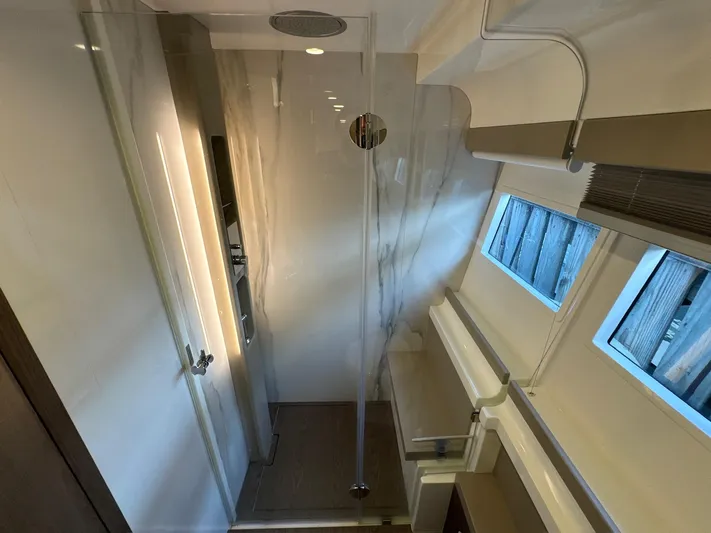 Time To Fly Yacht Photos Pics Luxurious bathroom interior of 2022 Ferretti Yachts 550 with modern design and natural lighting.