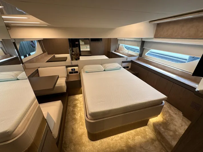 Time To Fly Yacht Photos Pics Luxurious bedroom interior of 2022 Ferretti Yachts 550 with modern design and ambient lighting.