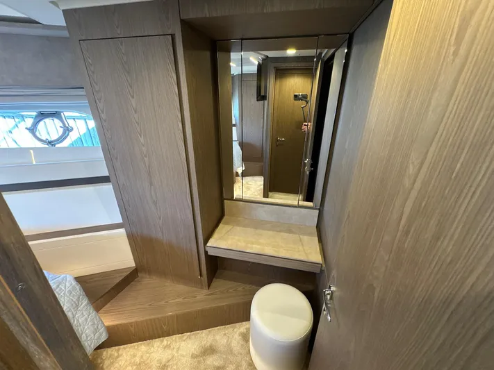 Time To Fly Yacht Photos Pics Interior of 2022 Ferretti Yachts 550, featuring a wooden vanity and mirror.