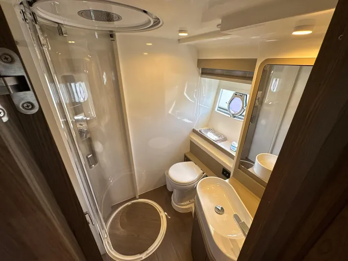 Time To Fly Yacht Photos Pics Luxurious bathroom in 2022 Ferretti Yachts 550, featuring modern fixtures and elegant design.