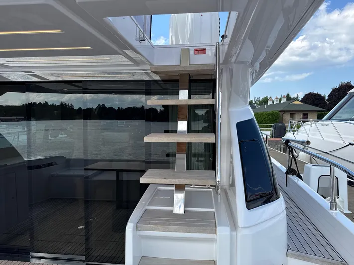 Time To Fly Yacht Photos Pics 2022 Ferretti Yachts 550, modern staircase, sleek design, docked by the water.