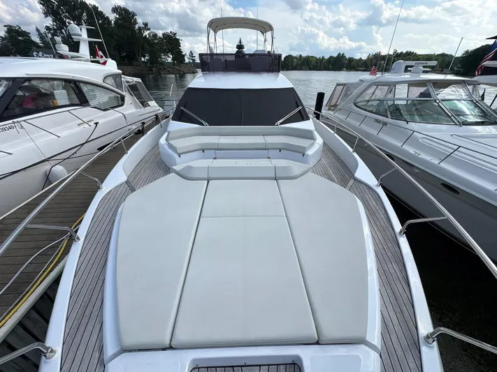 Time To Fly Yacht Photos Pics 2022 Ferretti Yachts 550 docked, showcasing spacious deck and sleek design.