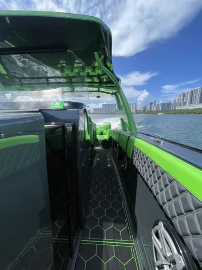  Yacht Photos Pics 2020 Midnight Express Open 43 boat with green accents cruising on water, city skyline in background.
