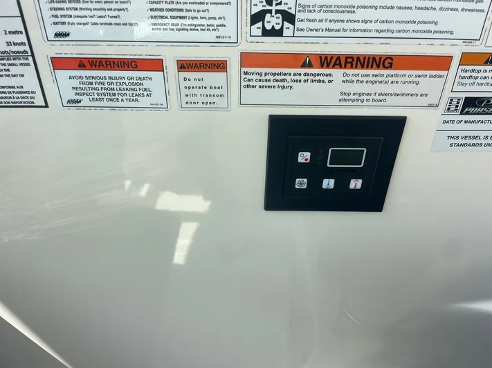  Yacht Photos Pics Control panel and warning labels on a 2012 Pursuit OS 315 Offshore boat.