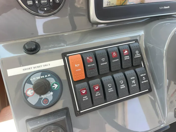  Yacht Photos Pics Control panel of a 2012 Pursuit OS 315 Offshore boat with various switches and buttons.
