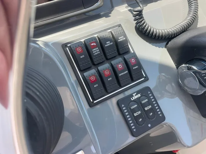  Yacht Photos Pics Control panel of a 2012 Pursuit OS 315 Offshore boat with various switches and buttons.