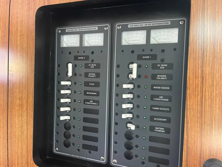  Yacht Photos Pics Electrical panel on 2012 Pursuit OS 315 Offshore boat, featuring AC distribution controls.