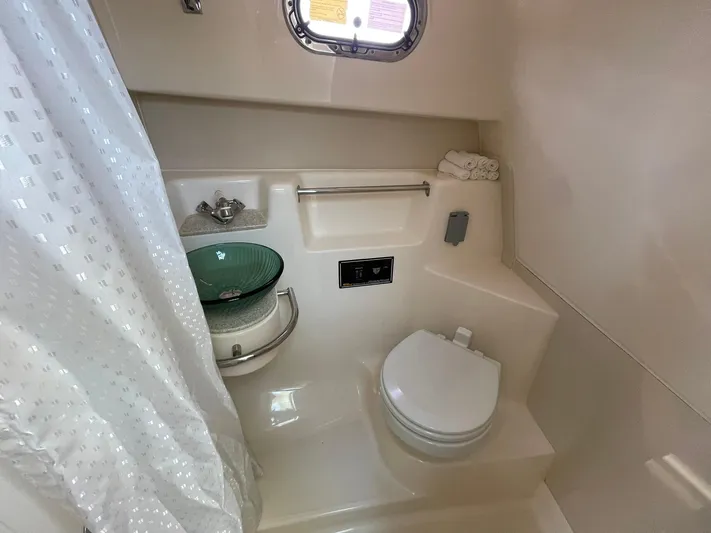  Yacht Photos Pics 2012 Pursuit OS 315 Offshore bathroom with shower, sink, and toilet.