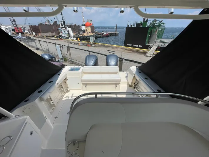  Yacht Photos Pics 2012 Pursuit OS 315 Offshore boat interior with dockside view and twin engines.