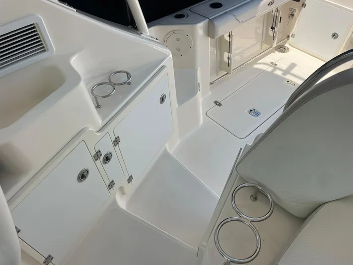  Yacht Photos Pics 2012 Pursuit OS 315 Offshore boat interior with storage compartments and cup holders.