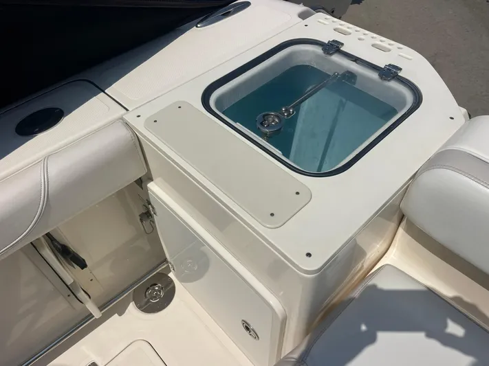  Yacht Photos Pics 2012 Pursuit OS 315 Offshore boat interior with livewell and seating area.