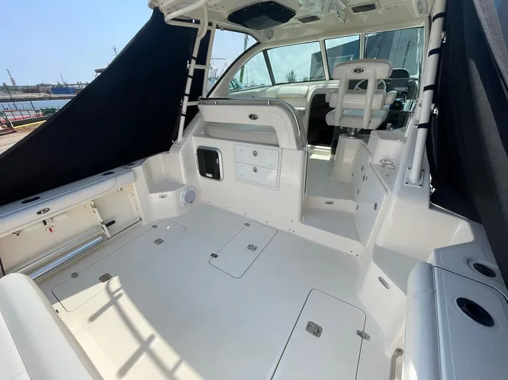  Yacht Photos Pics 2012 Pursuit OS 315 Offshore boat interior, featuring spacious deck and seating area.