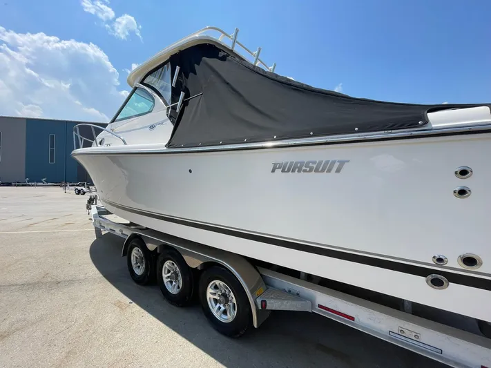  Yacht Photos Pics 2012 Pursuit OS 315 Offshore boat on trailer under clear blue sky.