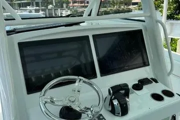  Yacht Photos Pics 2021 Yellowfin 39 boat dashboard with dual screens and steering wheel.