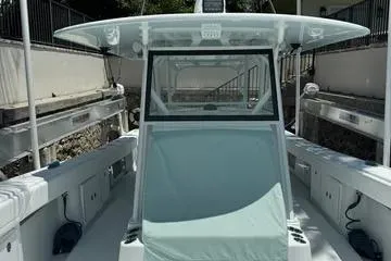  Yacht Photos Pics 2021 Yellowfin 39 boat interior with seating and console, docked in a marina.