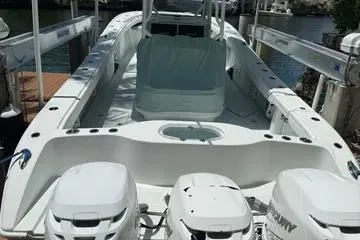  Yacht Photos Pics 2021 Yellowfin 39 boat with triple outboard engines docked at a marina.