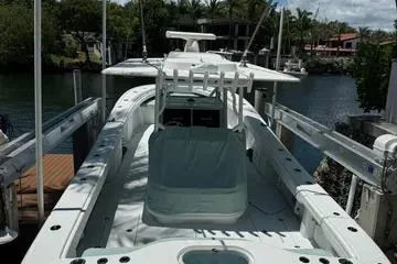  Yacht Photos Pics 2021 Yellowfin 39 boat docked near waterfront homes and lush greenery.