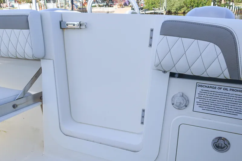  Yacht Photos Pics 2022 World Cat 280 CC-X boat interior with cushioned seating and safety notice.