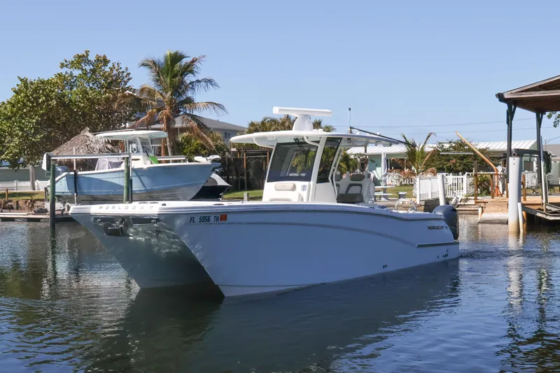  Yacht Photos Pics 2022 World Cat 280 CC-X boat docked in a serene marina setting.