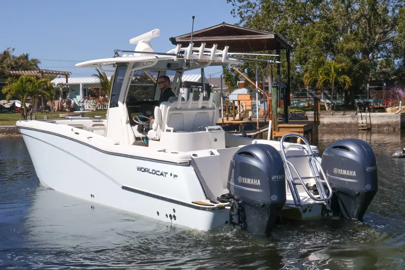  Yacht Photos Pics 2022 World Cat 280 CC-X boat with dual Yamaha engines on a calm waterway.
