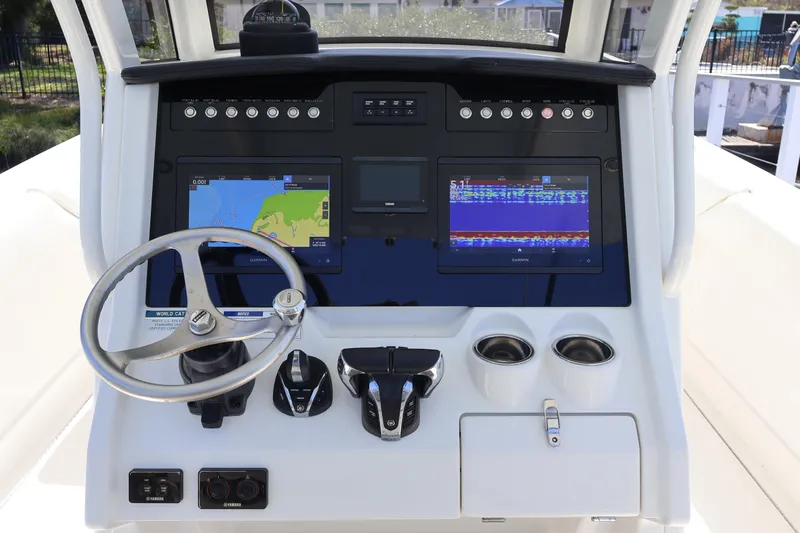  Yacht Photos Pics 2022 World Cat 280 CC-X boat dashboard with navigation screens and steering wheel.