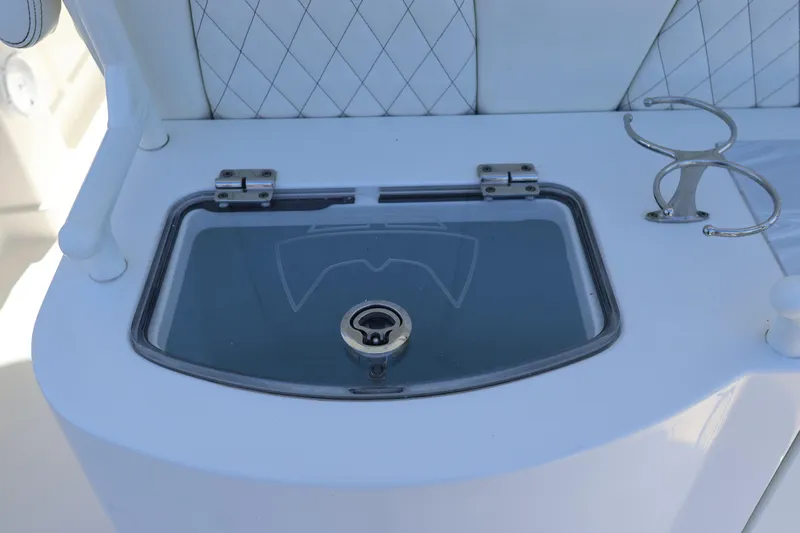  Yacht Photos Pics 2022 World Cat 280 CC-X boat detail with storage compartment and cup holder.