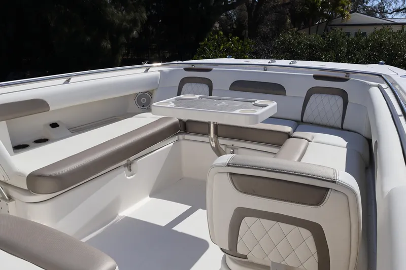  Yacht Photos Pics 2022 World Cat 280 CC-X boat interior with cushioned seating and table.
