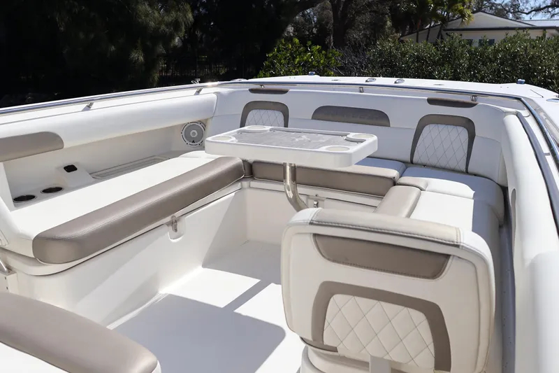  Yacht Photos Pics 2022 World Cat 280 CC-X boat interior with cushioned seating and table.