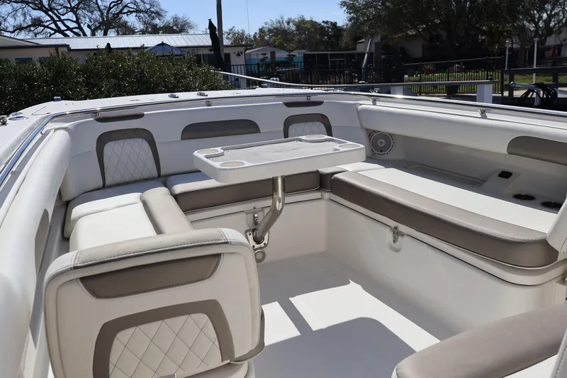  Yacht Photos Pics 2022 World Cat 280 CC-X boat interior with cushioned seating and table.