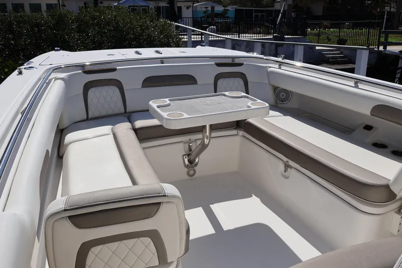  Yacht Photos Pics 2022 World Cat 280 CC-X boat interior with cushioned seating and table.