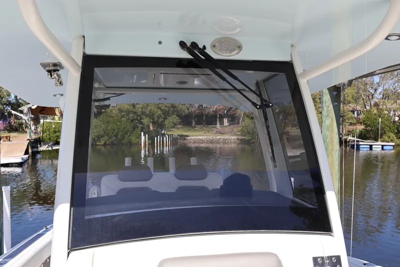  Yacht Photos Pics 2022 World Cat 280 CC-X boat windshield view with scenic waterway background.