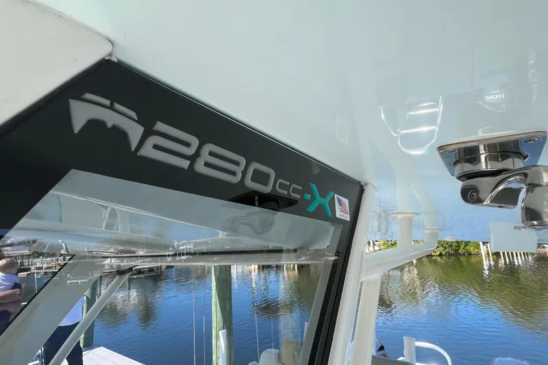  Yacht Photos Pics 2022 World Cat 280 CC-X boat detail with logo, docked by the water.