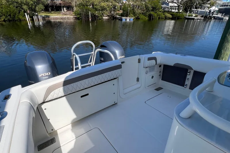  Yacht Photos Pics 2022 World Cat 280 CC-X boat interior with Yamaha 200 engines, docked by a serene waterfront.