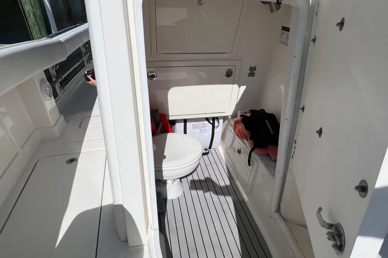  Yacht Photos Pics 2022 World Cat 280 CC-X boat interior with compact bathroom and storage.