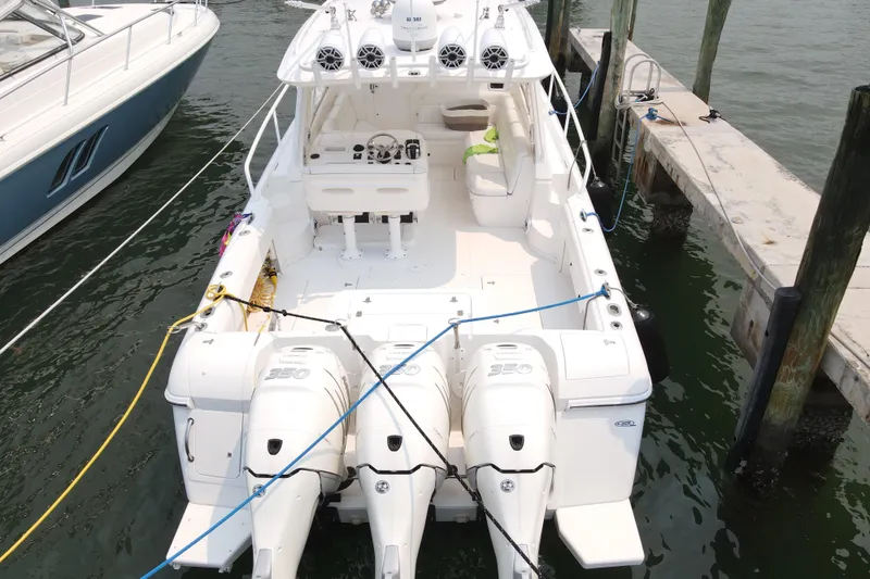  Yacht Photos Pics 2010 Intrepid 390 Sport Yacht docked, featuring triple outboard engines and spacious deck.