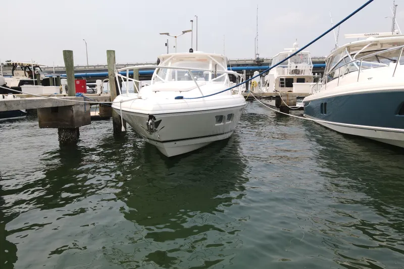  Yacht Photos Pics 2010 Intrepid 390 Sport Yacht docked at marina, surrounded by water and other boats.