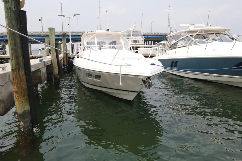  Yacht Photos Pics 2010 Intrepid 390 Sport Yacht docked at marina, surrounded by water and other boats.