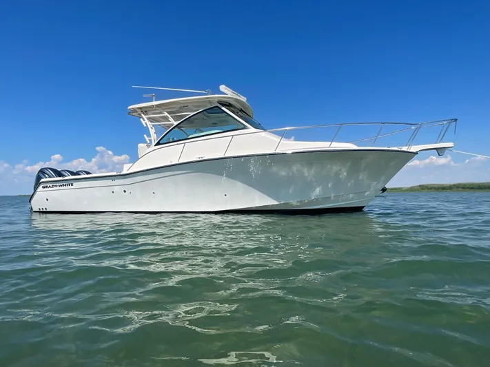  Yacht Photos Pics 2022 Grady-White Express 370 boat on calm water under clear blue sky.