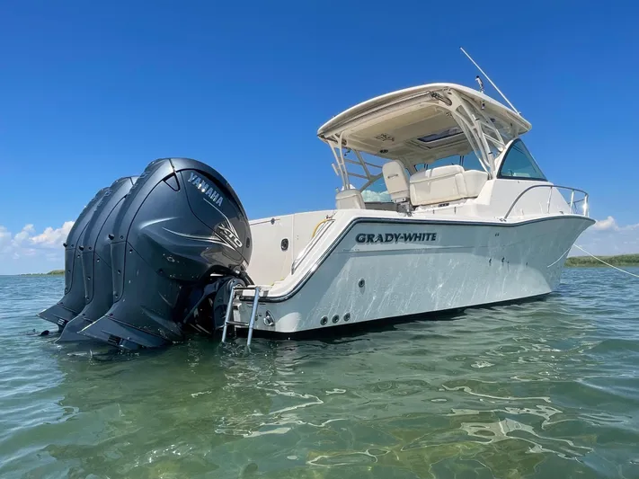  Yacht Photos Pics 2022 Grady-White Express 370 boat with Yamaha engines on clear water under blue sky.