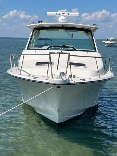  Yacht Photos Pics 2022 Grady-White Express 370 boat on clear water with blue sky background.