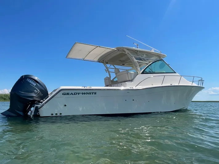  Yacht Photos Pics 2022 Grady-White Express 370 boat on water under clear blue sky.