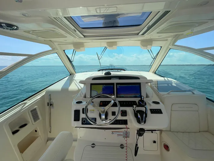  Yacht Photos Pics 2022 Grady-White Express 370 helm with ocean view, featuring modern navigation equipment.