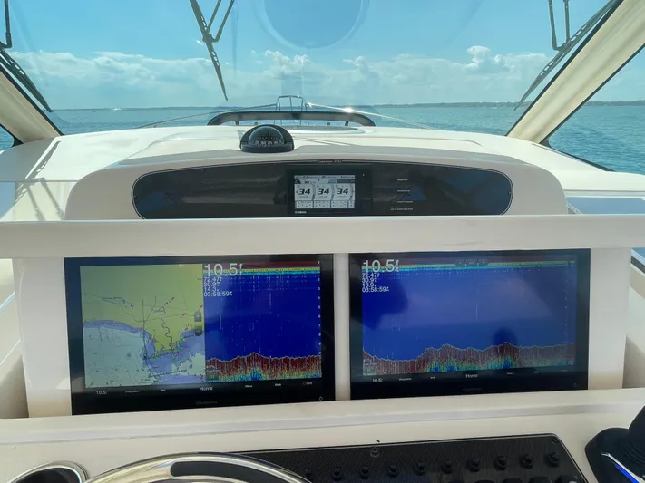  Yacht Photos Pics 2022 Grady-White Express 370 dashboard with dual navigation screens on open water.