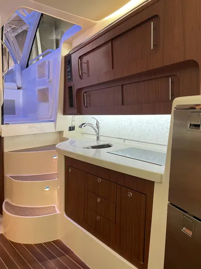  Yacht Photos Pics 2022 Grady-White Express 370 yacht interior with modern kitchen and wooden cabinetry.