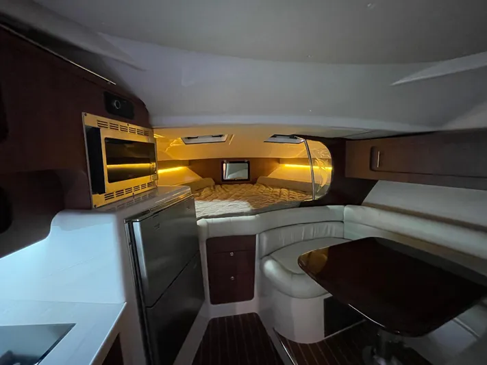  Yacht Photos Pics 2022 Grady-White Express 370 cabin interior with kitchenette, seating, and cozy sleeping area.