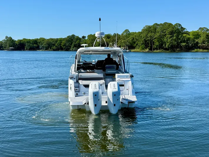  Yacht Photos Pics 2025 Beneteau Gran Turismo 36 yacht cruising on a serene lake.