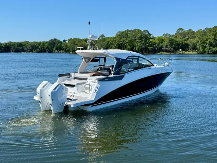  Yacht Photos Pics 2025 Beneteau Gran Turismo 36 yacht cruising on a serene lake.