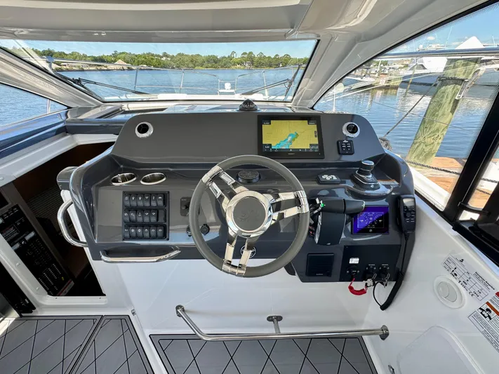  Yacht Photos Pics Helm of 2025 Beneteau Gran Turismo 36 yacht with navigation controls and steering wheel.